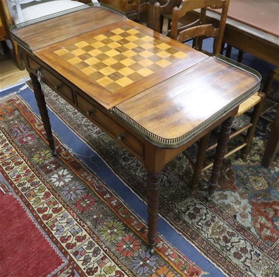 A Regency mahogany writing / games table with reversible leather lined chequer surface with interior backgammon W.100cm